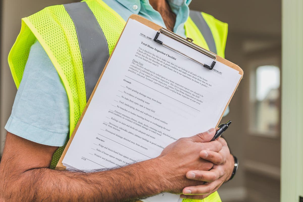Home inspector reviewing checklist during property inspection