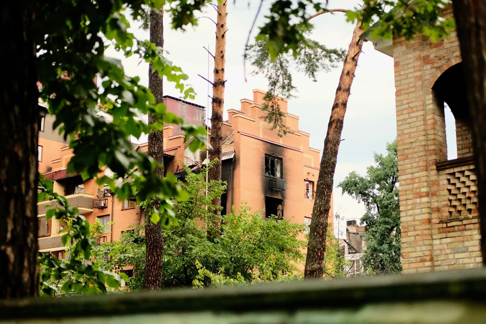 A fire-damaged residential building in Arlington, Texas with charred exterior damage, showing the kind of structure that requires professional fire and smoke damage restoration