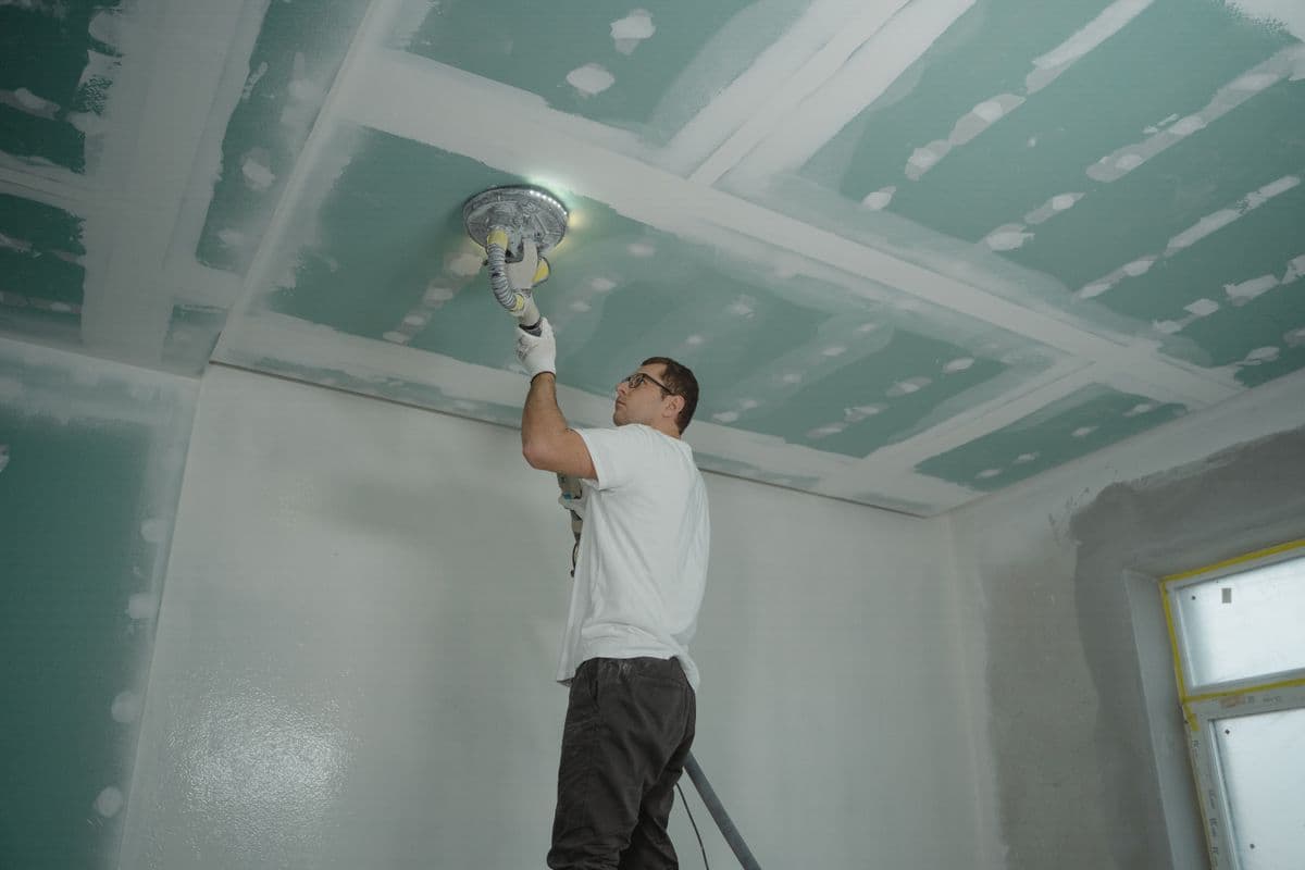 Water damage stain on a residential ceiling in a DFW home showing the visible discoloration and texture damage that requires professional ceiling water damage repair