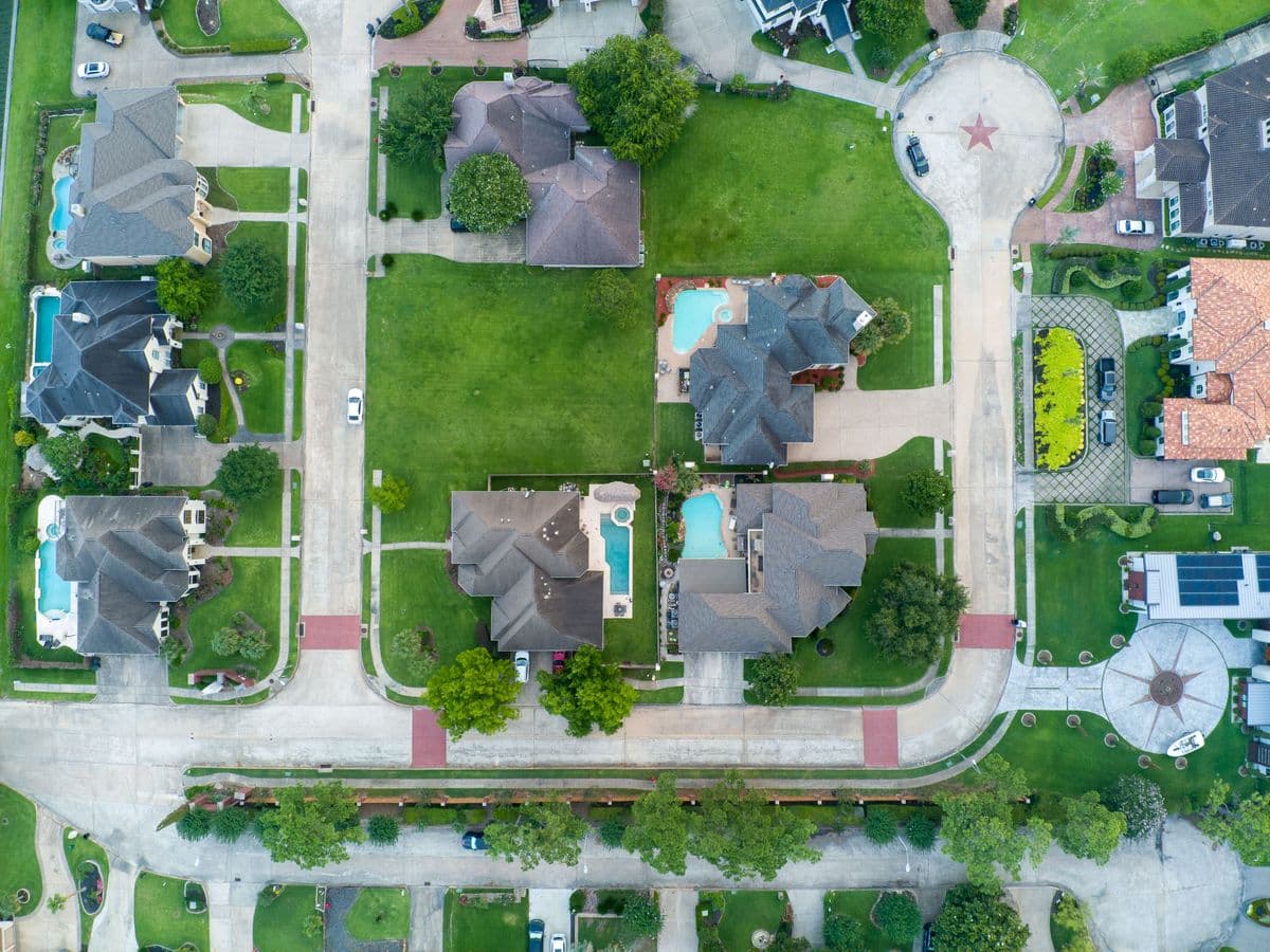 Aerial view of a residential neighborhood in Plano, Texas showing the typical slab-on-grade brick homes and tree-lined streets common to Collin County
