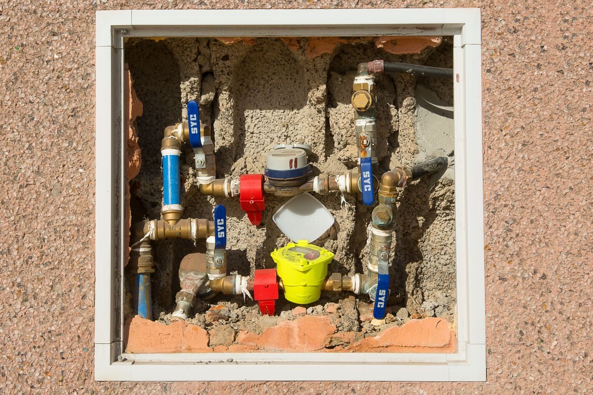 Open water meter box with isolation valves, the first stop when hunting a hidden leak behind finished walls